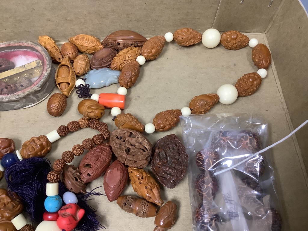 A quantity of Chinese peach stone and nut carvings